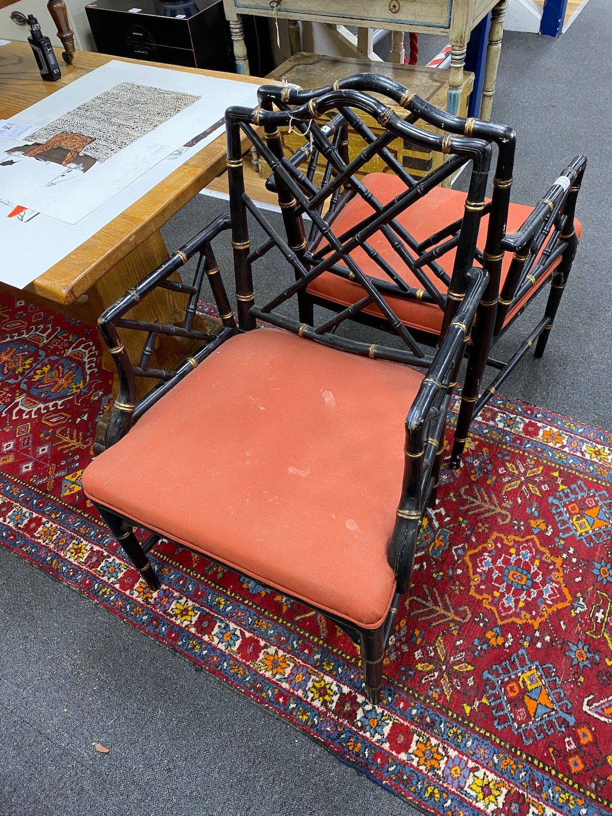 A pair of Regency style lacquer lattice back elbow chairs (one a.f.), width 56cm, depth 49cm, height 94cm